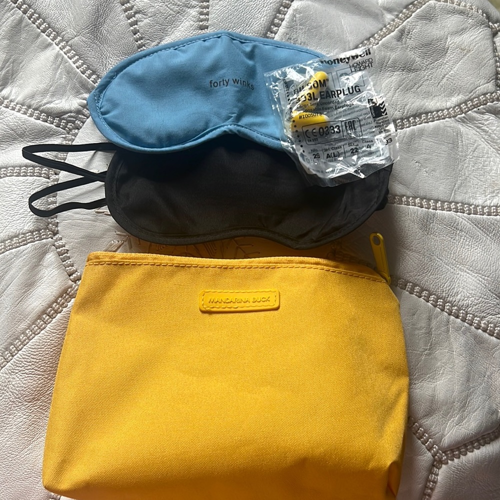 Mandarina Duck travel amenity bag with two sleep masks and earplugs
